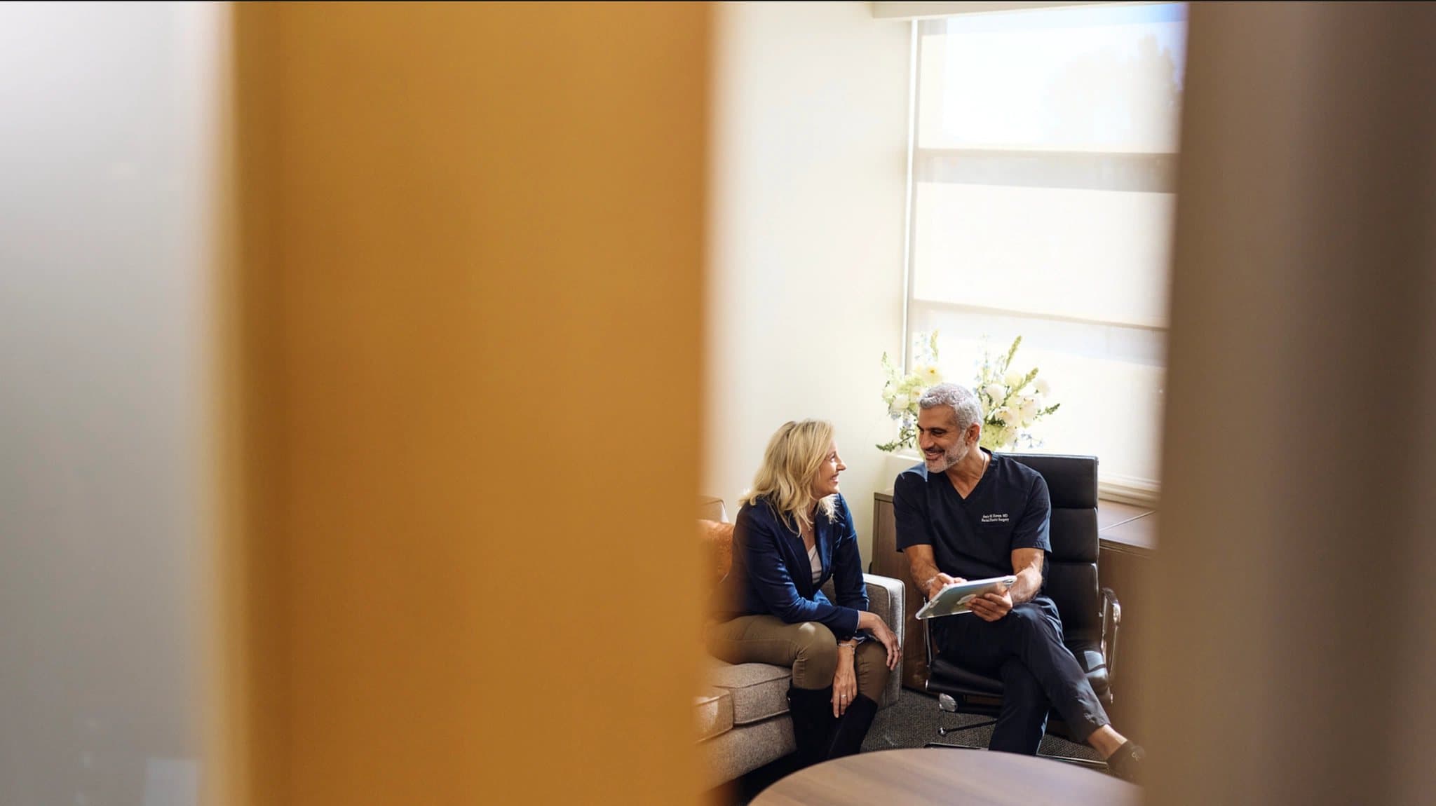 A provider and a patient talking in a consultation room